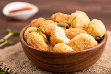 Fried crispy Chicken Nuggets with ketchup, microgreen on brown wooden. Diet, healthy eating. side view, selective focus