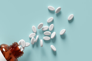 Amber glass medicine bottle lies on its side against light blue surface with NAD+ white tablets scattered. Concept of anti-aging therapy, medicine and healthcare. Copy space. 3d render, illustration