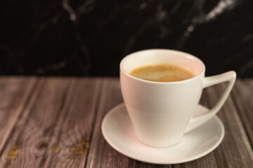 Obraz premium Coffee with foam in a white cup. Background with a cup of coffee