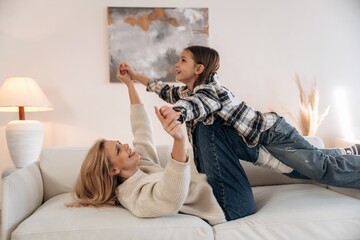 Good relationships, cozy. Mother and daughter are together in domestic room