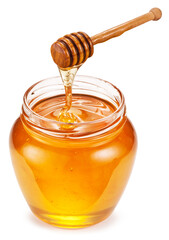 Honey dripping from honey spoon into honey pot on white background. File contains clipping path.