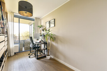 A stylish and contemporary home office featuring a workspace with a desk, chair, and decorative elements including plants and natural light.