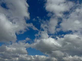 Fototapeta premium The sky is blue with clouds. The clouds are white and fluffy
