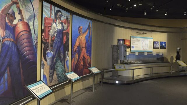 Vibrant murals illustrate labor and construction themes inside the Hoover Dam Visitors Center, showcasing the dedication of workers in a historic engineering landmark.
