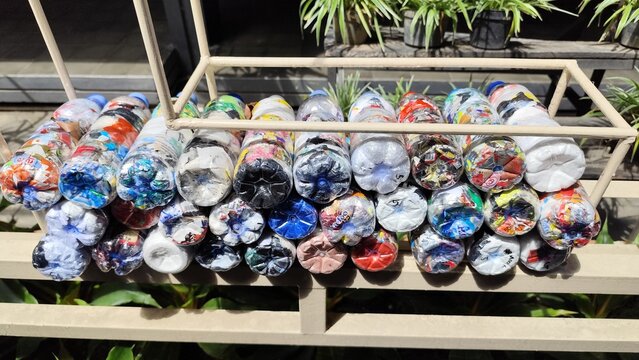 Colorful Plastic Bottle Ecobricks Filled with Non-Organic Waste for Creative Recycling Solution and Sustainable Household Waste Management

