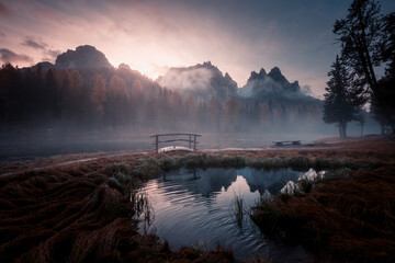 Mystical fog over Lake Antorno at dusk with a view of the Cadini di Misurina ridge. National Park Tre Cime di Lavaredo, Dolomite, Italy, Tyrol, Europe.