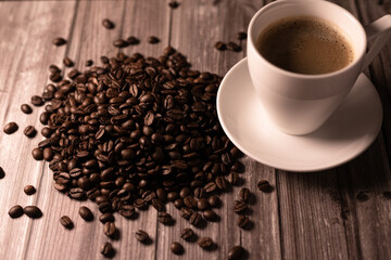 Light from the window on coffee beans.Coffee beans spilled on the table