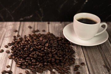 Espresso coffee and coffee beans on the table. Coffee in a white cup