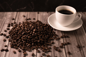 Espresso coffee and coffee beans on the table. Coffee in a white cup