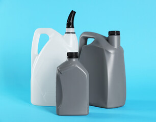 Different plastic canisters on light blue background