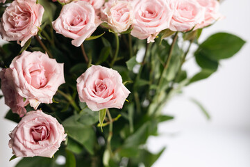Close-up, bouquet of small pink roses on a white background.