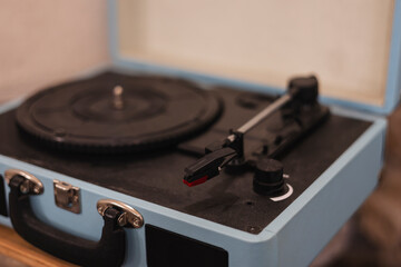 Close up of a vintage record player sitting on a table in a music studio.