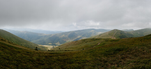 Panoramic view of the mountain range. Vacation in the mountains with a magnificent view. Valley high in the mountains.
