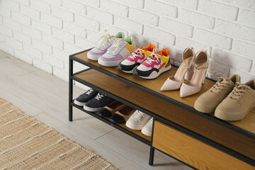 Shoe storage. Shelving unit with different footwear indoors