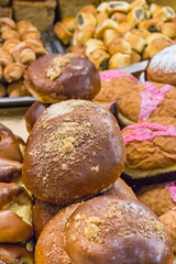 Fresh glazed donuts and other cookies on market stall or in grocery shop. Delicious dessert
