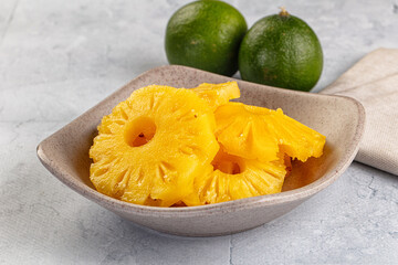 Sweet canned pineapple slices in syrope