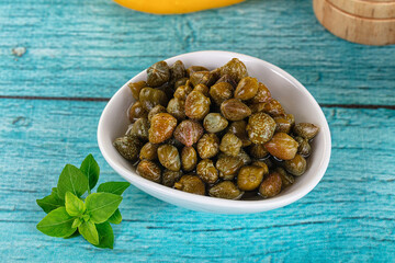 Pickled canned capers in the bowl
