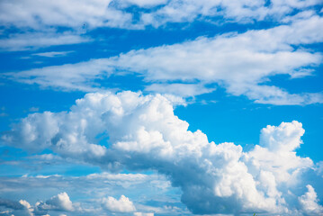 Blue sky fluffy white clouds on summer season bright clear skyline with beautiful cloudscape. Panorama blue sky clouds pattern on daylight with copy space. Cumulus cloudscape air climate sunny day © aFotostock