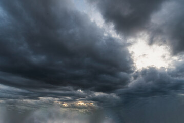 Dramatic dark storm thundercloud rain clouds on black sky background. Dark thunderstorm clouds...