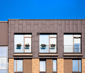 City view on a sunny day. Modern buildings, walls and windows. 