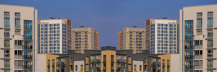 City view on a sunny day. Modern buildings, walls and windows. 
