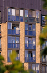 City view on a sunny day. Modern buildings, walls and windows. 