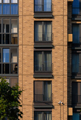 City view on a sunny day. Modern buildings, walls and windows. 