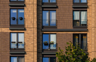City view on a sunny day. Modern buildings, walls and windows. 