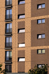 City view on a sunny day. Modern buildings, walls and windows. 