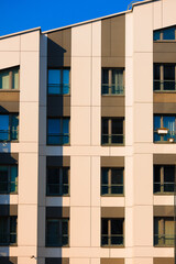 City view on a sunny day. Modern buildings, walls and windows. 