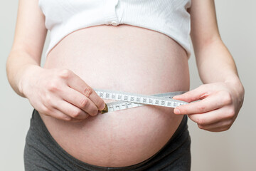 belly size during pregnancy, a woman measures her belly circumference in the ninth month of...