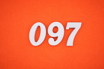 The numbers are made of white painted wood placed on an orange paper background.