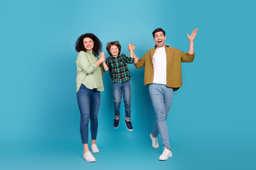 Happy family enjoying quality time, parents holding their child in a joyful pose against a vibrant...