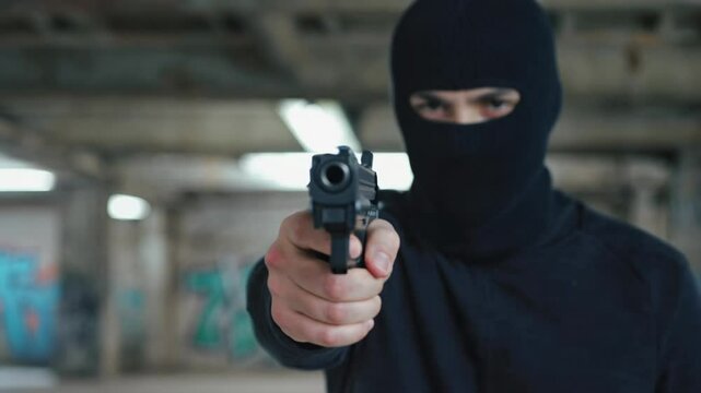 4k video of a criminal aiming a gun.