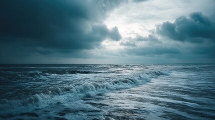 Obraz premium Waves crash powerfully against each other under a dark sky filled with turbulent clouds. The chaotic ocean reflects the turmoil of a stormy evening, creating a dramatic atmosphere with deep colors
