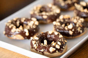Healthy gluten-free donuts covered in chocolate and almonds, Mallorca, Balearic Islands, Spain