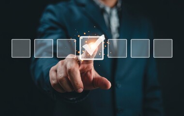 Businessman's hand touching a checkmark in a virtual screen, with floating boxes on a dark background for a business quality control concept.