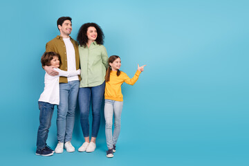 Happy family of four enjoying quality time together against a vibrant blue background, showcasing...
