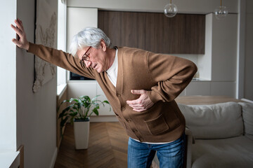 Afflicted senior man feel severe retrosternal pain with breathing difficulty, gripping chest....