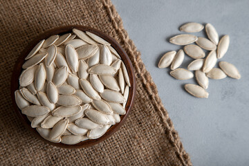 A bowl with full of pumpkin seeds,top view