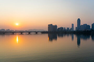 Fototapeta premium Sunset scenery of Jiangbei Business CBD and Dongjiang Bridge in Huizhou, China