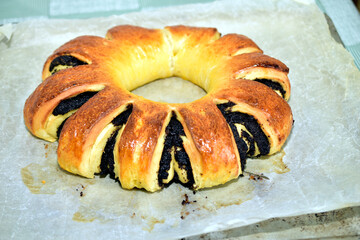 The pie with poppy seed filling lies on a baking sheet.