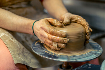 Close-up of male potter's hands making a vase. Pottery. Making ceramics.