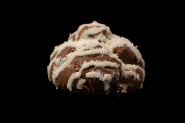 Profiteroles with coconut cream on a black background.