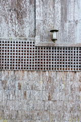 Weathered wood panels and decorative lantern rustic setting architectural detail close-up view textured aesthetic