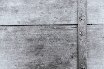 Industrial metal fasteners on weathered wood surface close-up texture rustic environment detailed view material concept