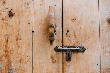 Locking mechanism on rustic wooden door close-up architectural detail natural environment focused view security concept