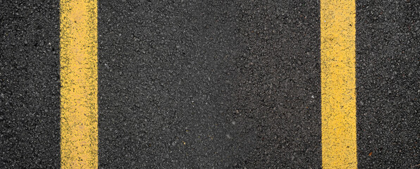 Close-up asphalt road texture with yellow line