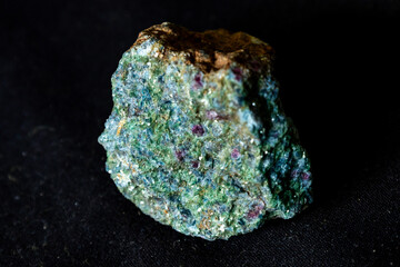 A pistachio green Epidote rock sample with trace of red garnet