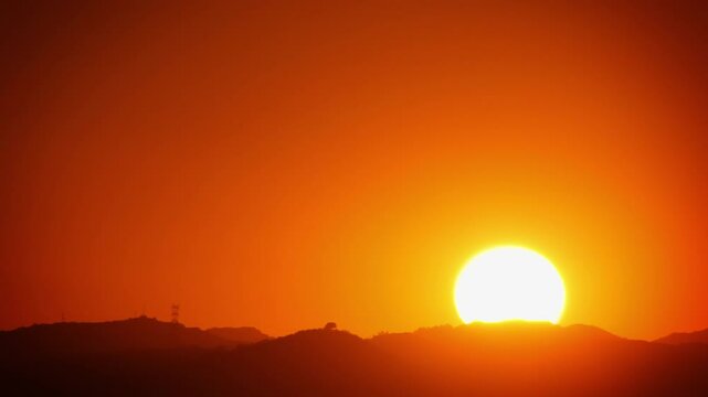 Time Lapse of the sun setting behind some mountains